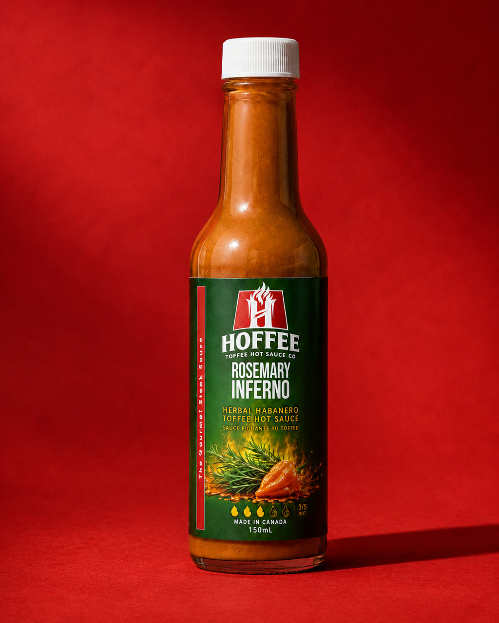 Bottle of Hoffee Rosemary Inferno Toffee Hot Sauce on a white background